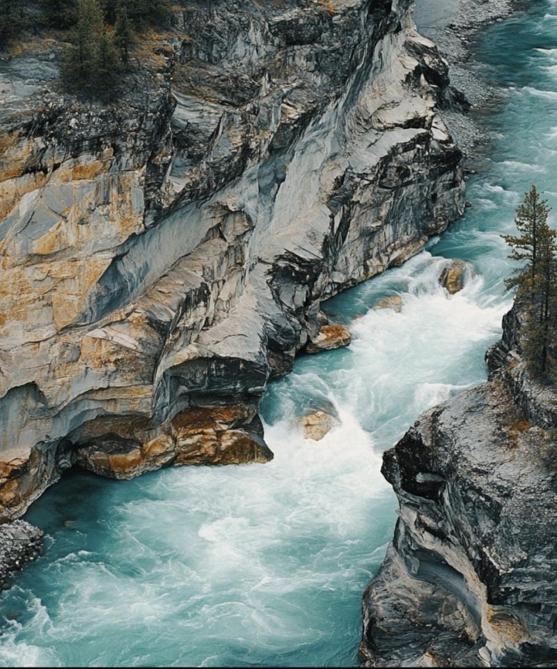 Aerial view of a river flowing tumultuous between rocky banks