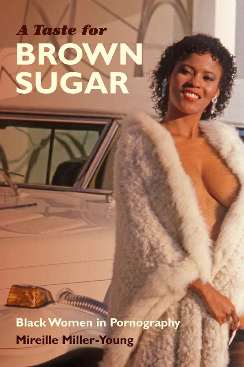 Young, attractive black woman wearing a white fur coat opened in front